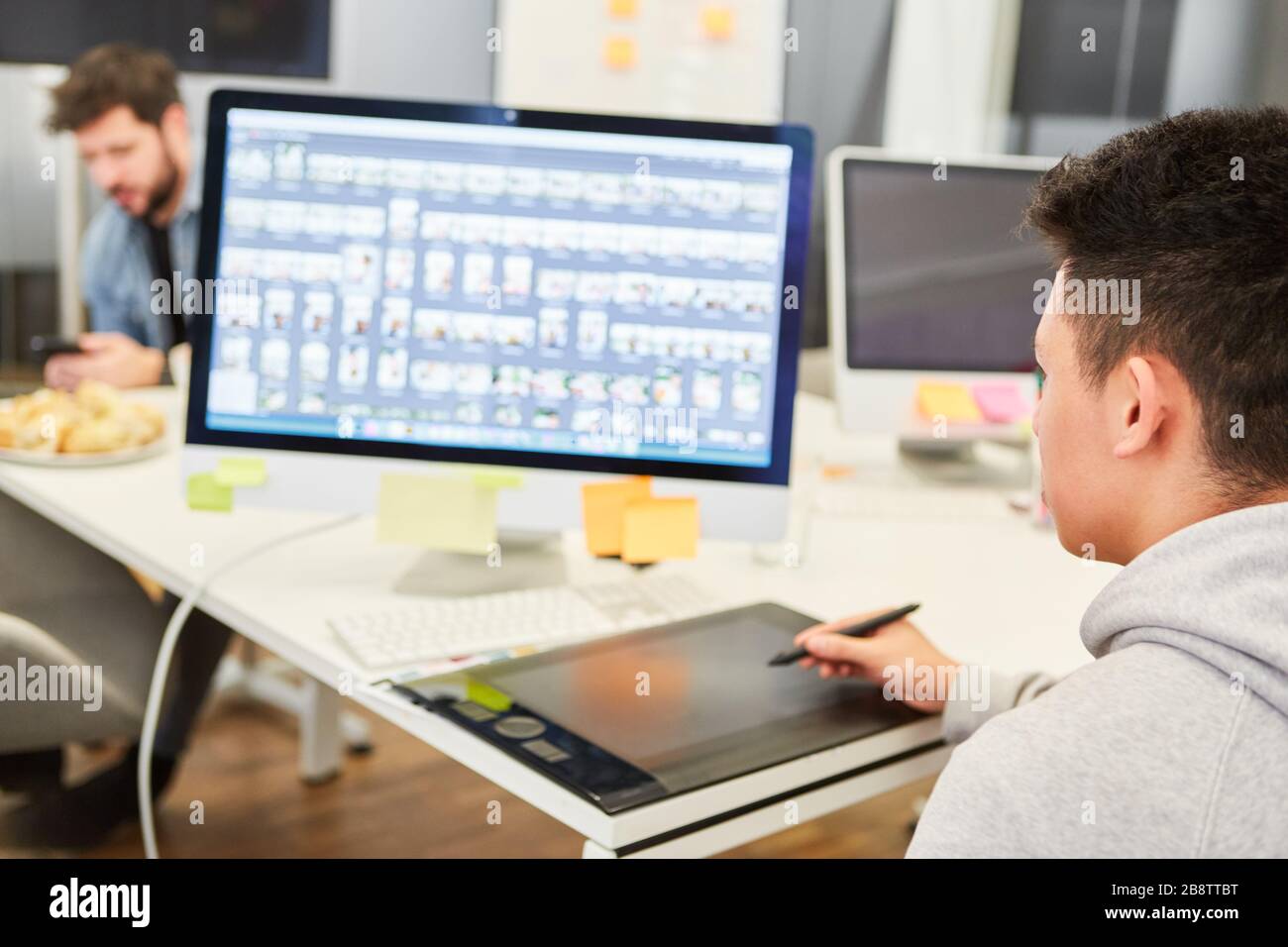 Young man as graphic designer on tablet computer designing a website Stock Photo