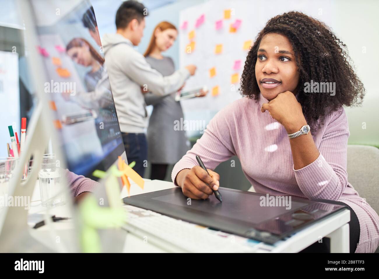 African woman as graphic designer in training on tablet computer Stock Photo