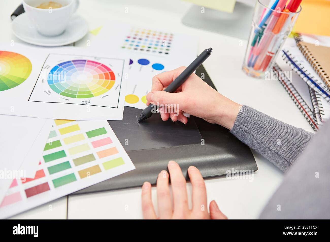 Hand from graphic designer draws a draft with pen on the tablet computer Stock Photo