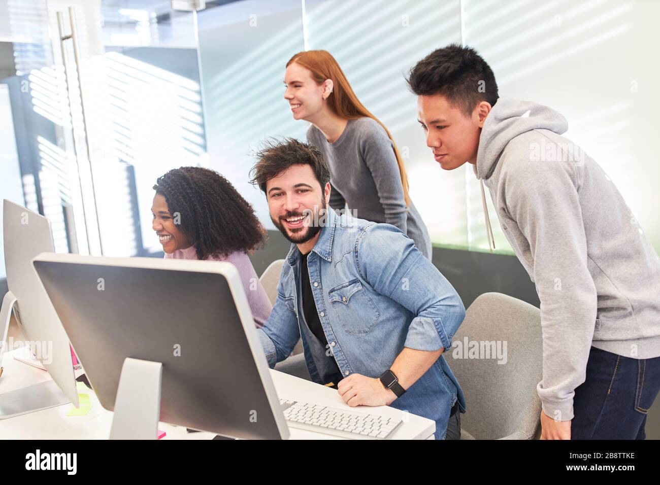 Creative young web designer team develops a project on the computer Stock Photo