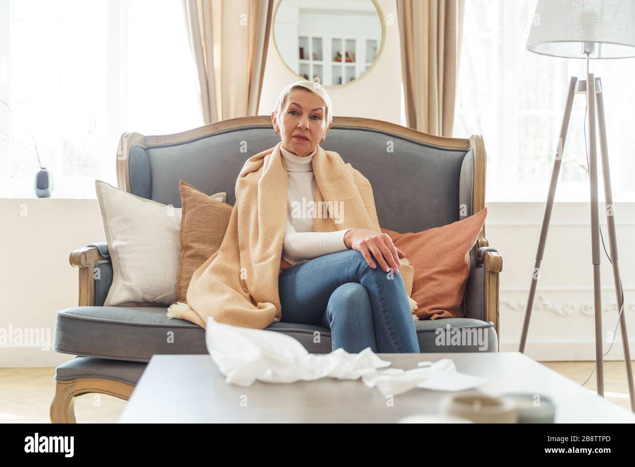 Serene senior lady relaxing on the sofa Stock Photo