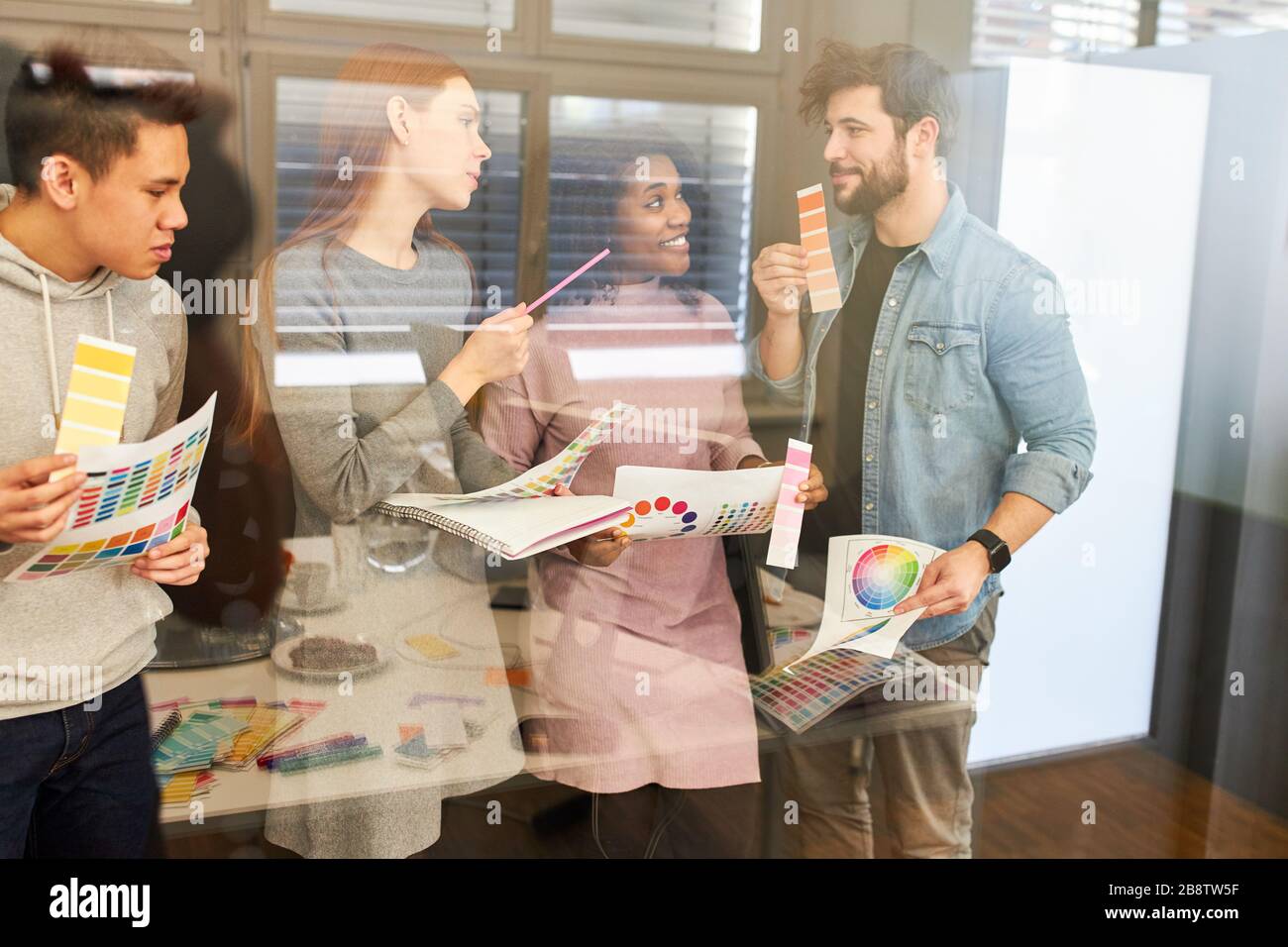 Creative team of a design agency brainstorming the color selection of a website Stock Photo