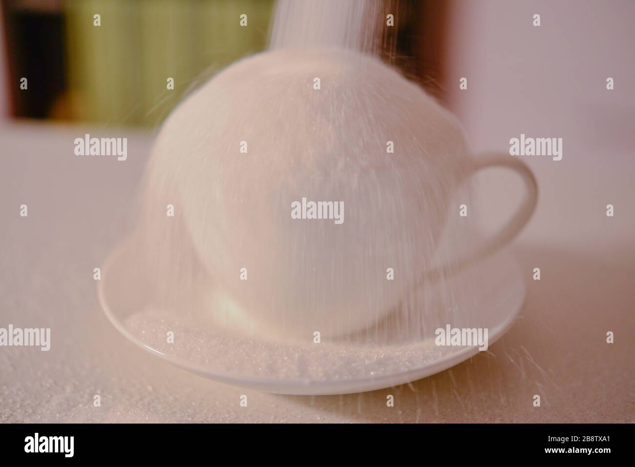 Cup and Saucer of Sugar Overflowing Cooking at Home in Self Isolation
