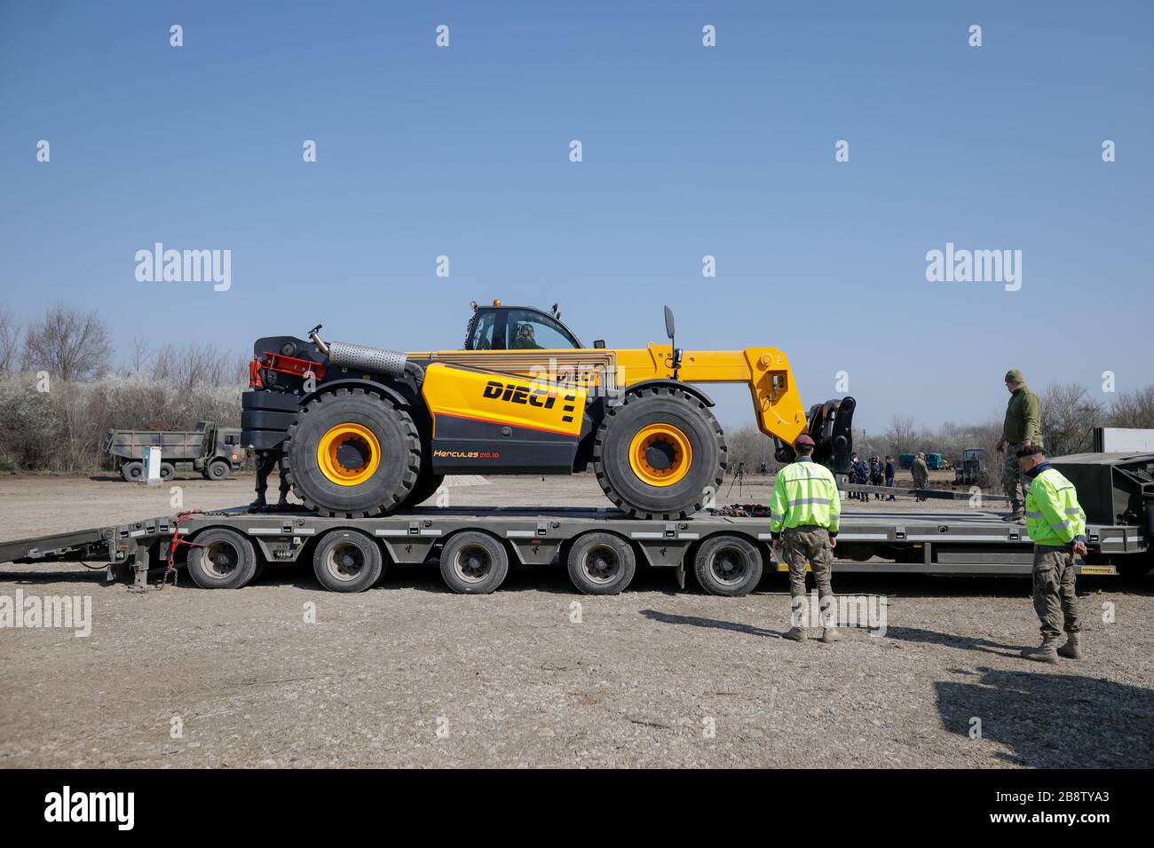 Otopeni, Romania - February 19, 2020: Heavy machinery of the Romanian Army level the ground for a campaign mobile hospital (ROL 2) to treat Covid-19 p Stock Photo