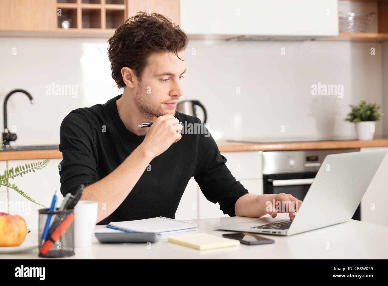Young man working at home. Home office, remotely working concept Stock Photo