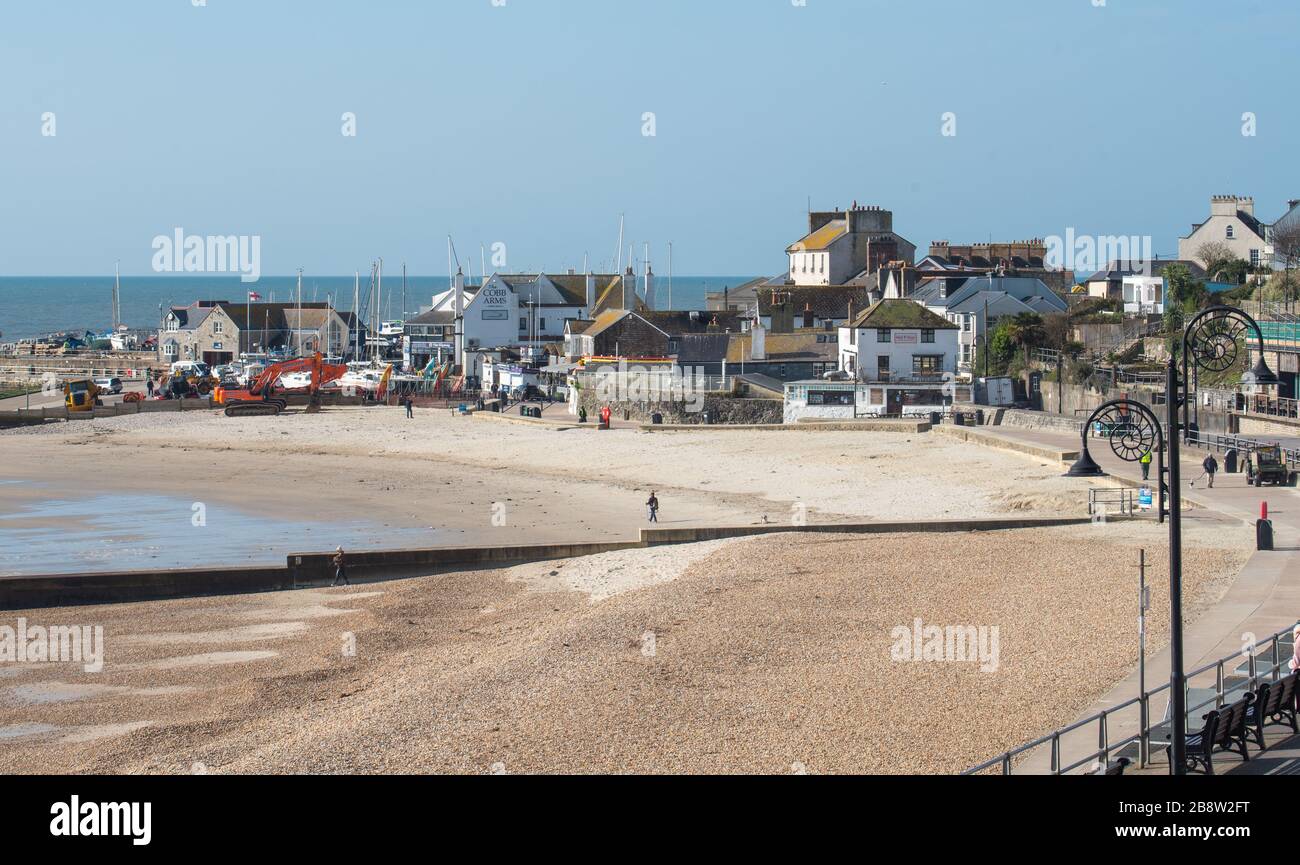 Lyme Regis, Dorset, UK. 23rd Mar, 2020. UK Weather: Lyme Regis' beaches were almost empty as people appear to be following Government advice to engage in social distancing and/or stay away from busy areas amid the coronavirus outbreak. Credit: Celia McMahon/Alamy Live News Stock Photo