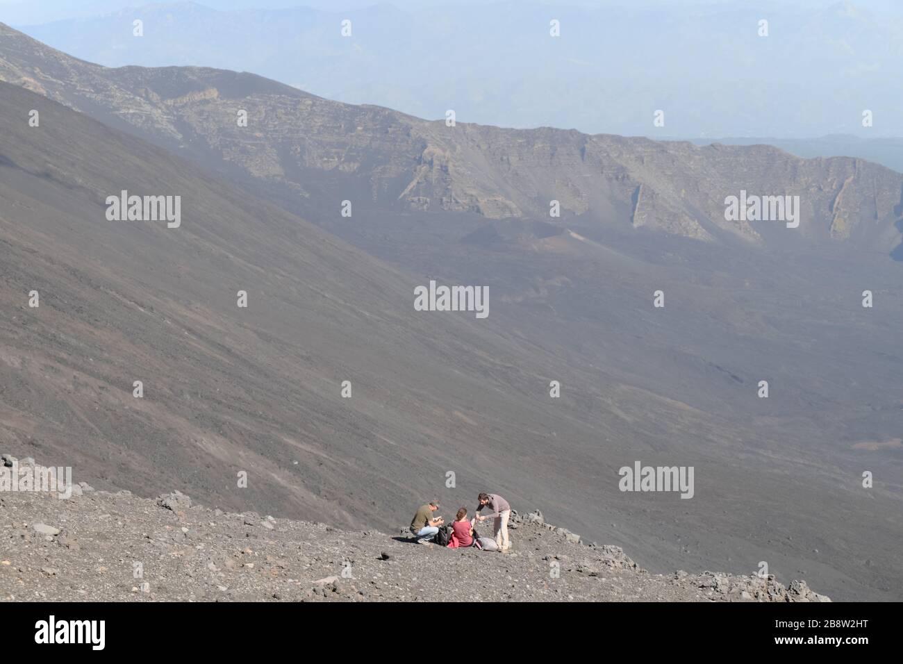 Tourists On The Edge Of Bove Valley In Etna Park, Sicily Stock Photo