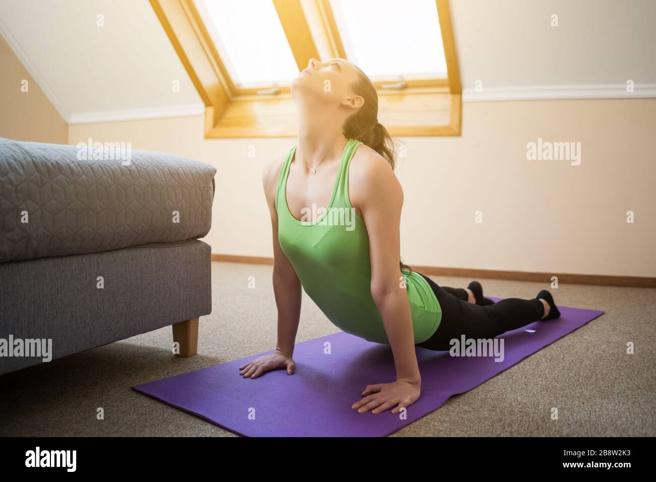 Young woman is practicing yoga at home. Bhujangasana / Cobra Pose Stock ...
