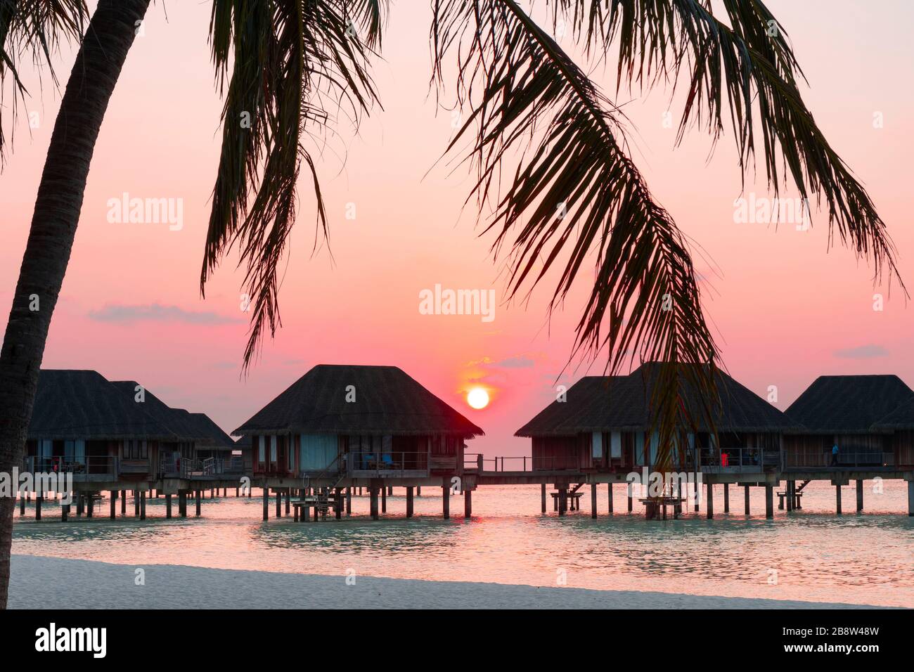 Sandy beach at sunset of tropical island in the Maldives Stock Photo