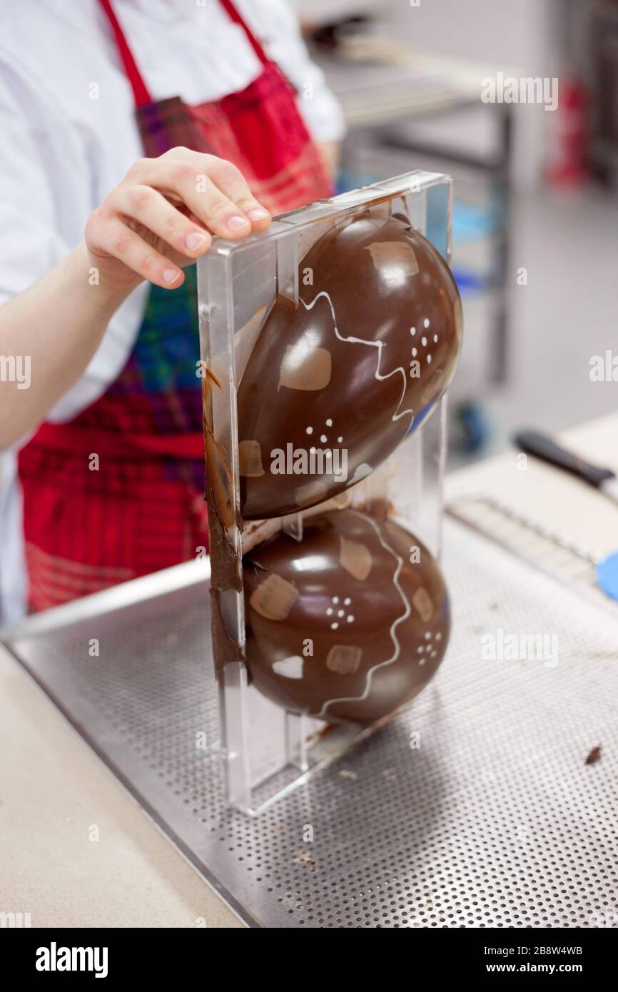 Making chocolate. Making chocolate easter eggs. Chocolate factory Stock