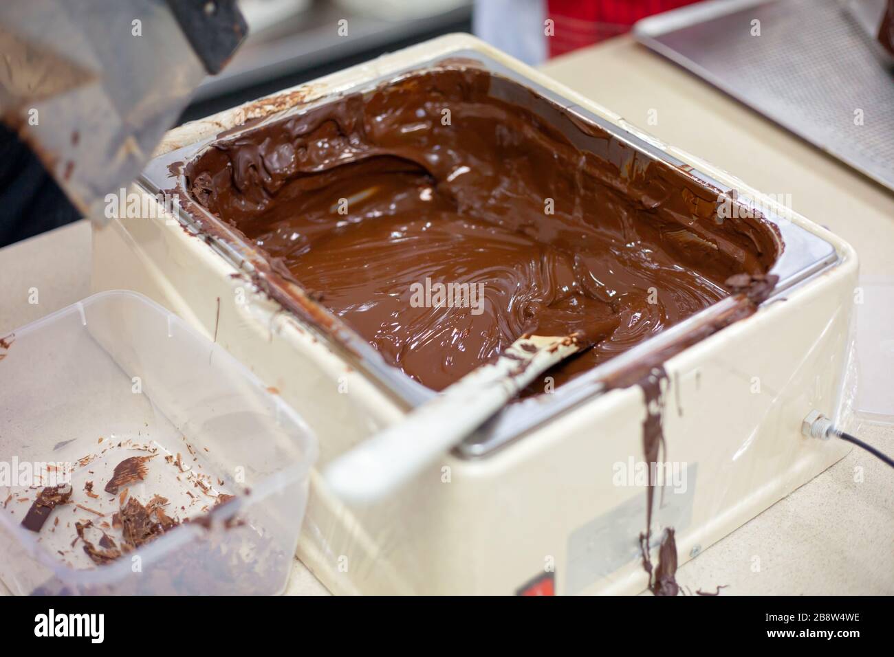 Making chocolate. . Chocolate factory. Liquid chocolate in a pan. Stock Photo