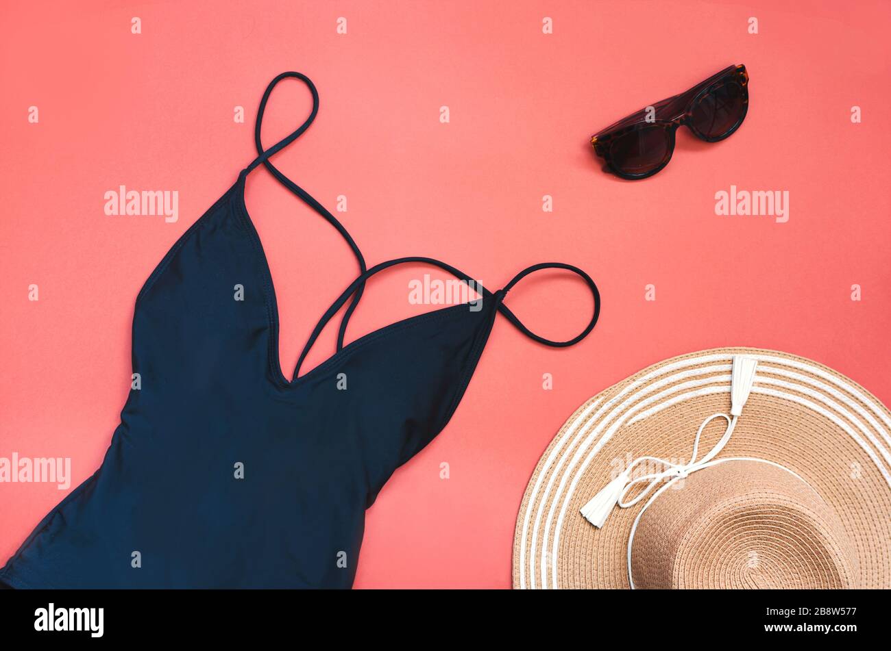 Swimming suit with sunglasses and straw hat for summer. Flatlay Stock Photo
