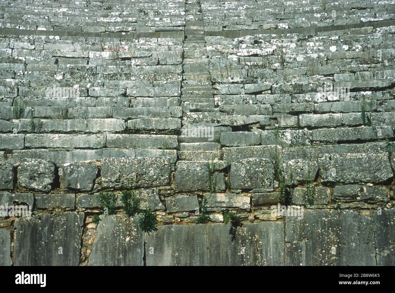 Detail view of the ancient Greek theatre at Dodoni, Ioannina, Epirus, Greece, showing curved rows of stone seats looking down on the stage and steps up to each level. Dodoni is one of 15 Ancient Greek Theatres with tentative status as a UNESCO World Heritage Site. Stock Photo