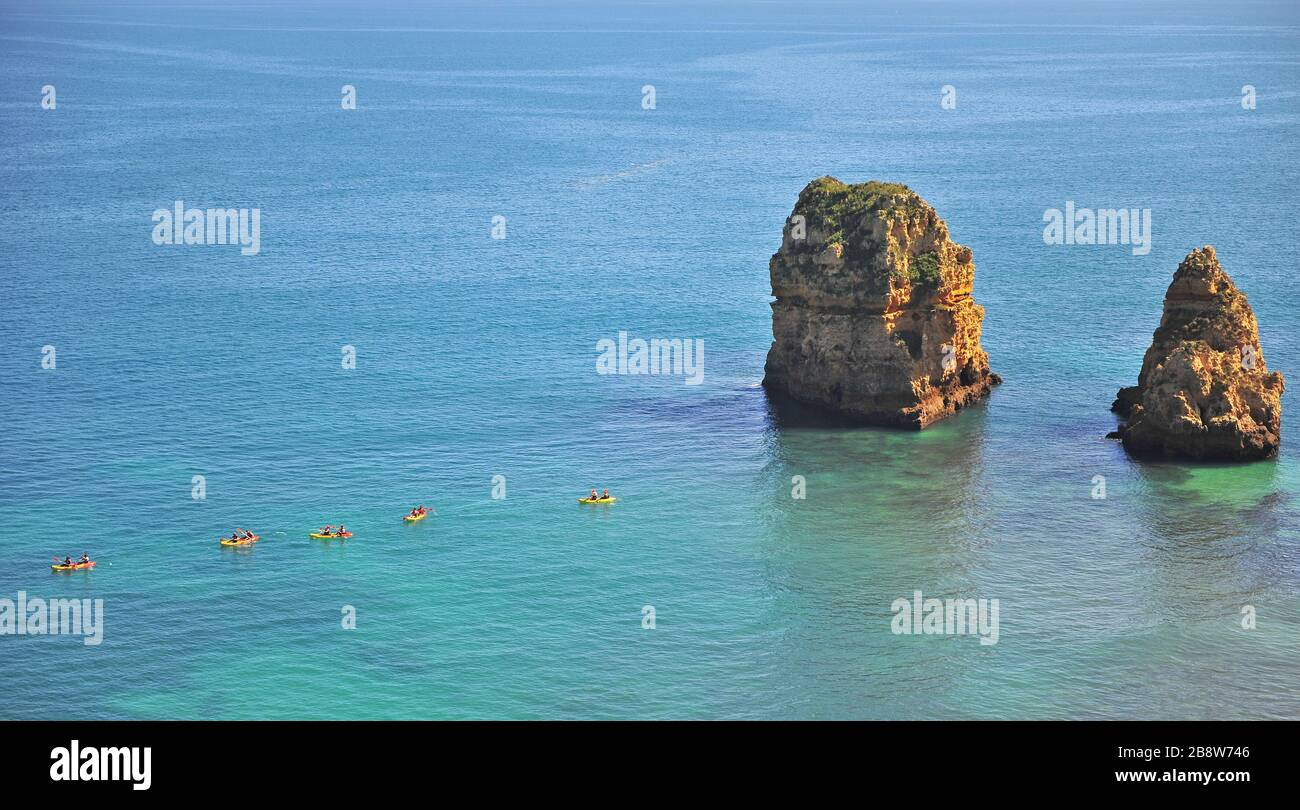 Group of touristic canoes discover the cliffs, Lagos, Portugal Stock Photo