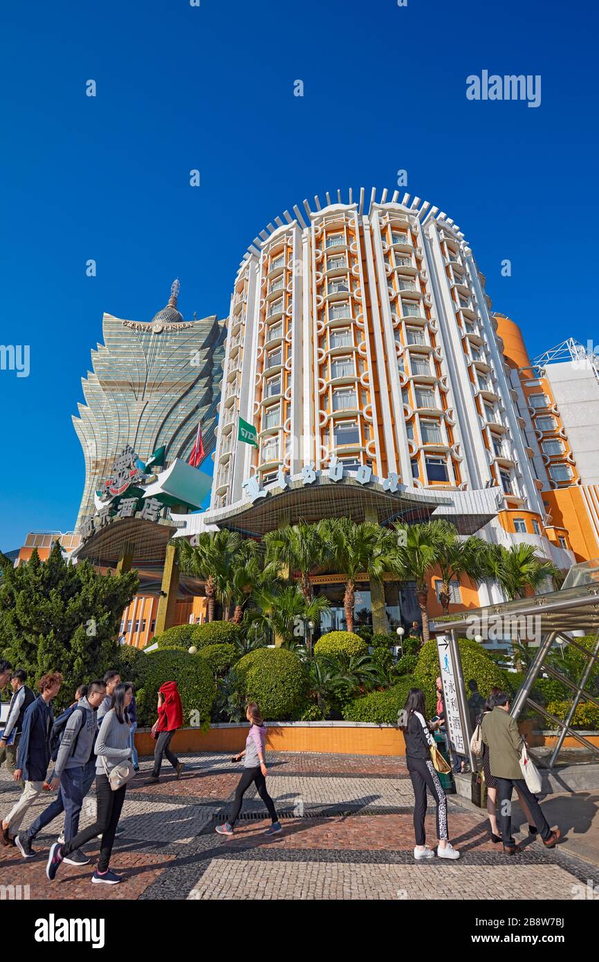 People passing by the Hotel Lisboa. Macau, China. Stock Photo