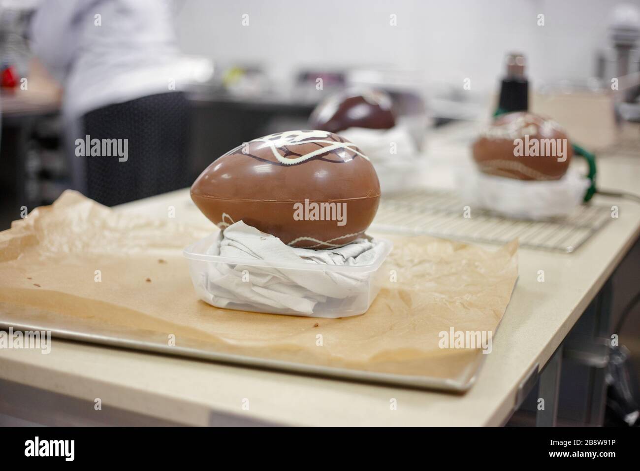 Making chocolate. Making chocolate easter eggs. Chocolate factory Stock