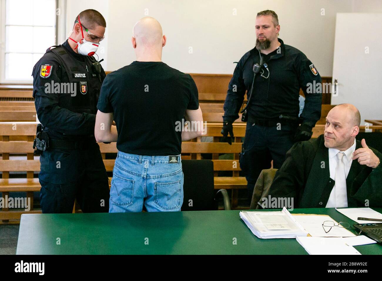 23 March 2020 Schleswig Holstein Neumunster A Judicial Officer Wearing A Face Mask Removes The Handcuffs Of The Accused 2nd From Left At The Beginning Of The Trial The Suspected Member Of The