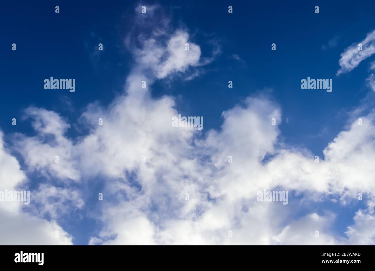 Beautiful white and fluffy clouds in a deep blue sunny sky Stock Photo ...