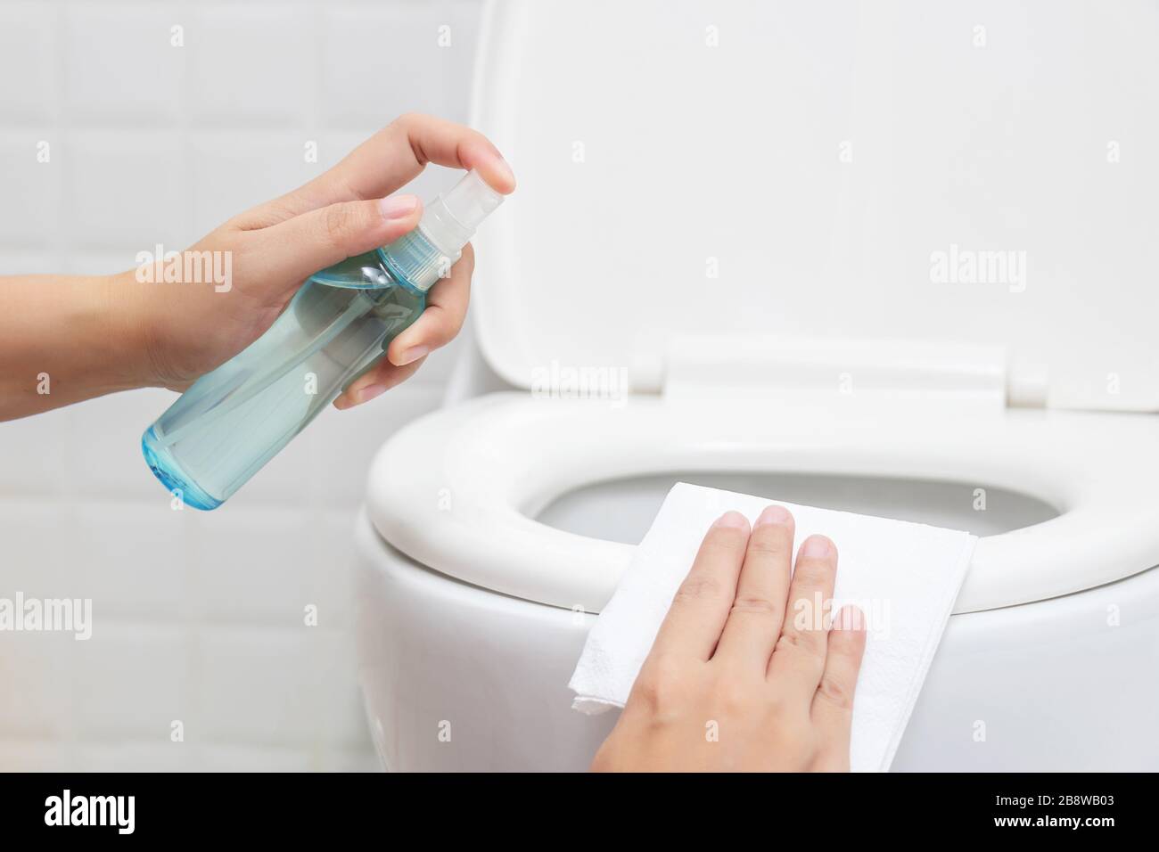 disinfect, sanitize, hygiene care. people using alcohol spray on toilet