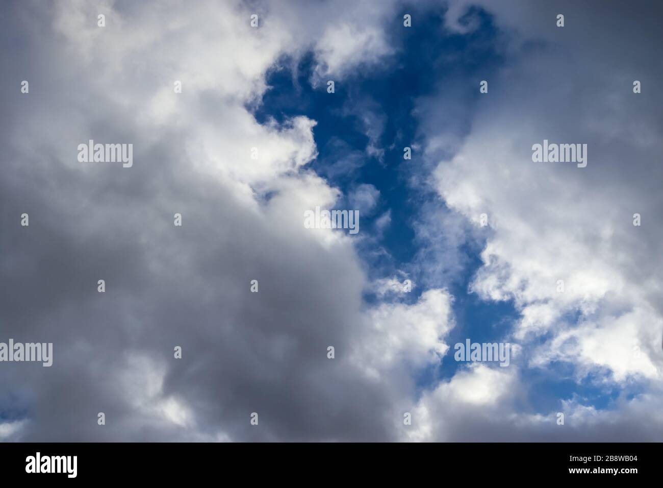 Beautiful white and fluffy clouds in a deep blue sunny sky Stock Photo ...