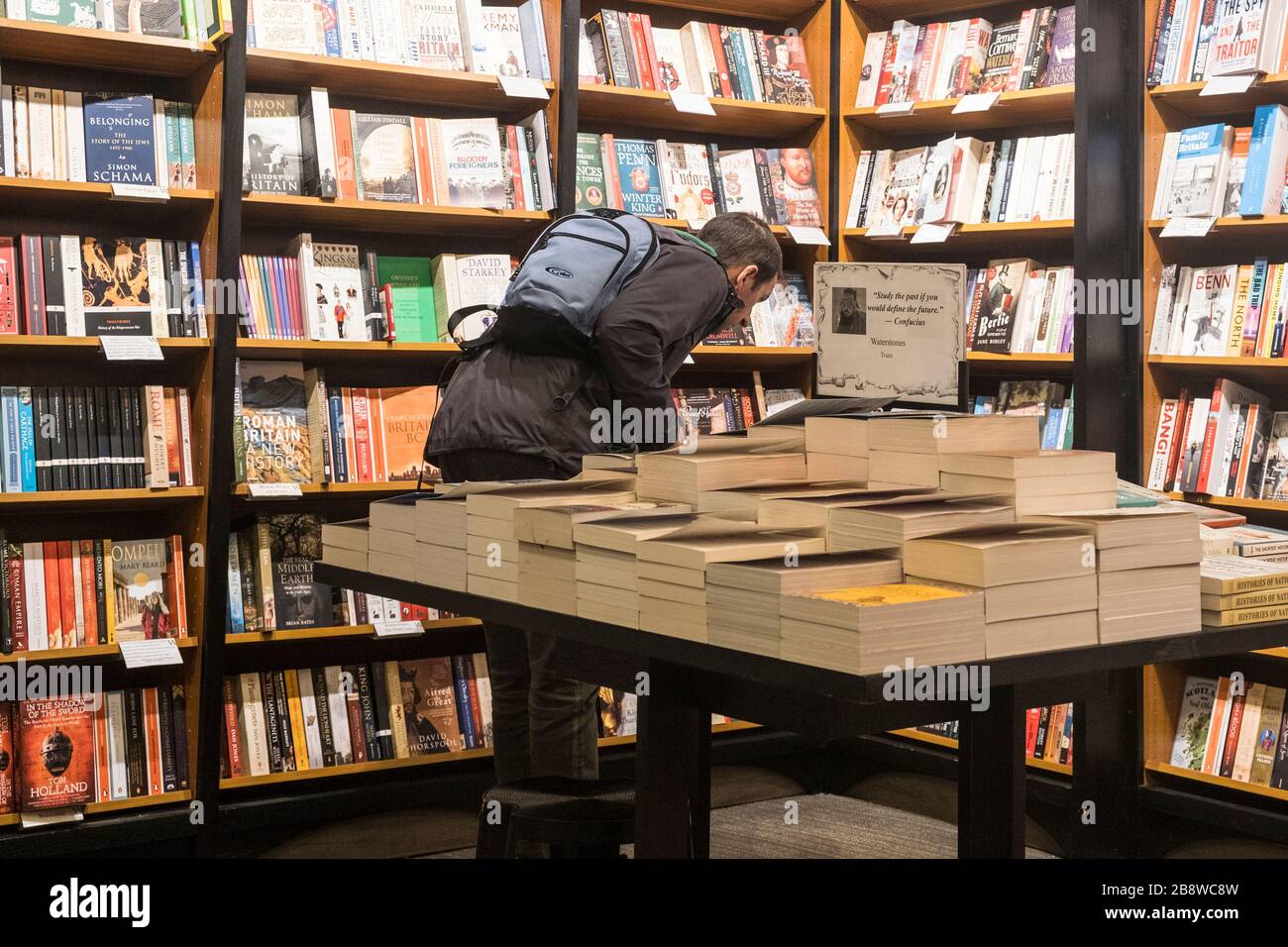 A customer browsing in a Waterstones Bookshop store in Truro in Cornwall. Stock Photo