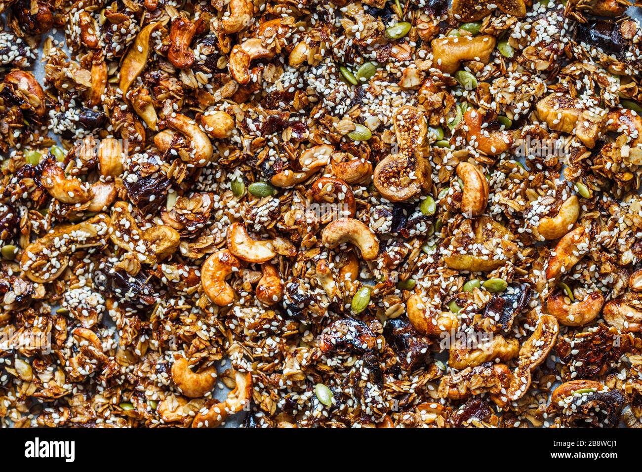 Crispy homemade granola with nuts, dried fruits and sesame seeds on a