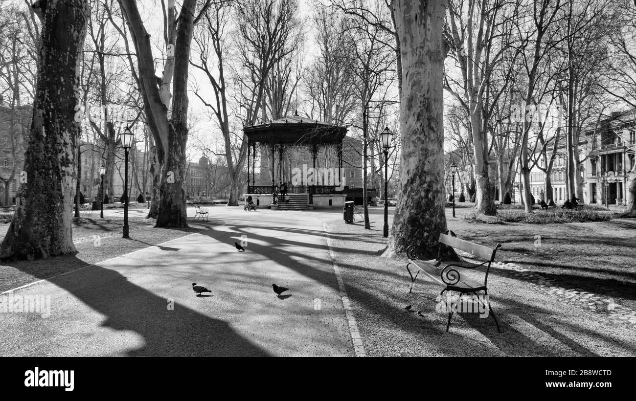 Empty Zagreb streets during corona virus epidemy. Empty music pavilion on Zrinjevac square with only few people passing by Stock Photo