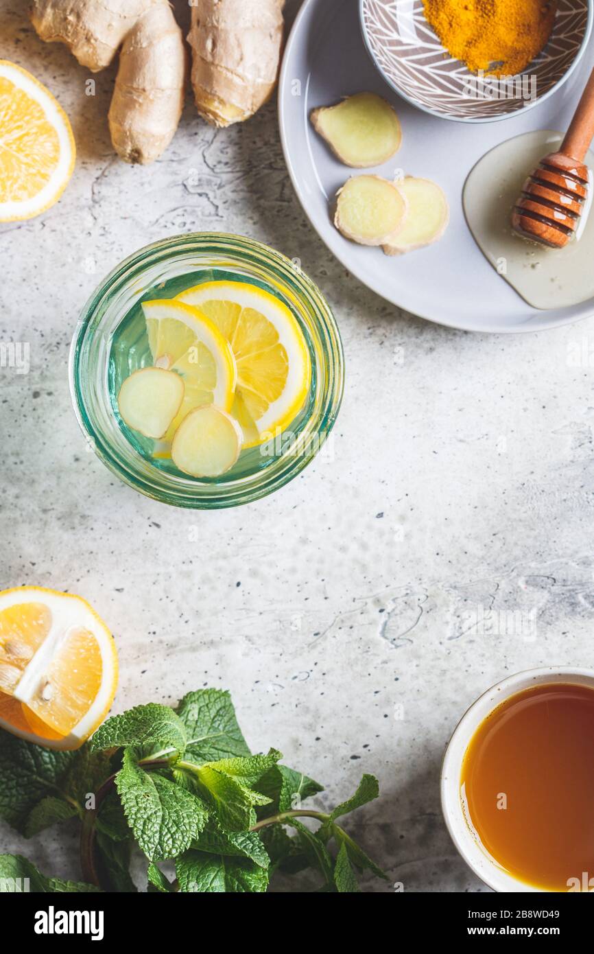 Warm drinks with turmeric, ginger, honey, mint and lemon. Beverage for raising immunity concept. Stock Photo