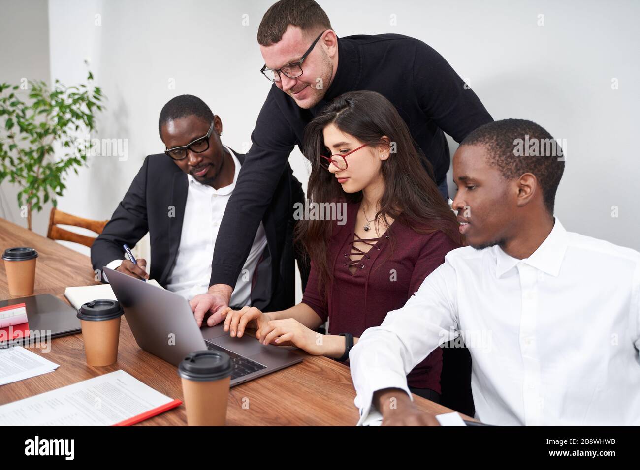 Young happy business people working together in modern office ...
