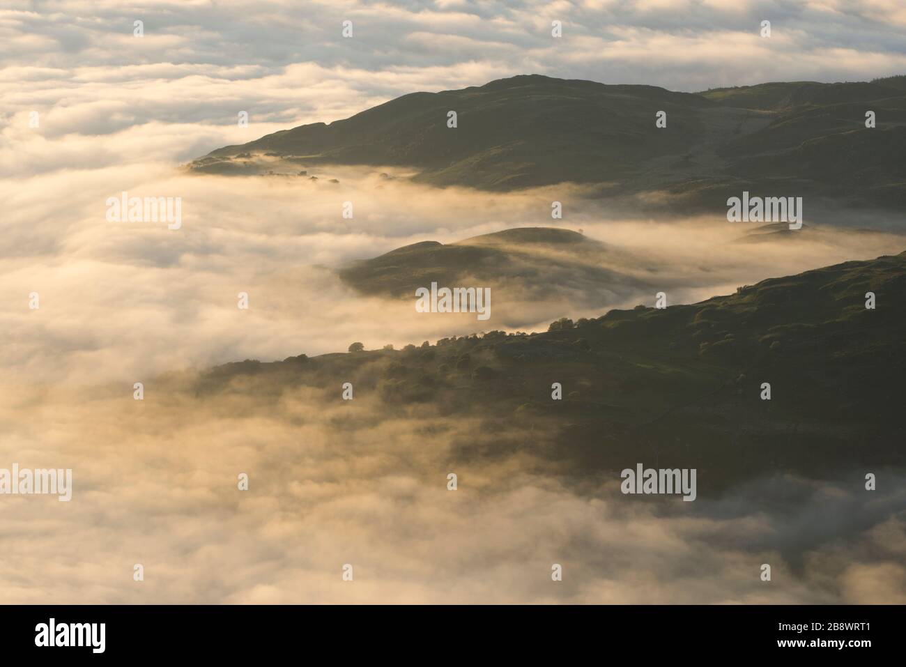 Mist in the valleys viewed from Cyfrwy, The Saddle, Cadair Idris, Snowdonia, North Wales, UK. Stock Photo