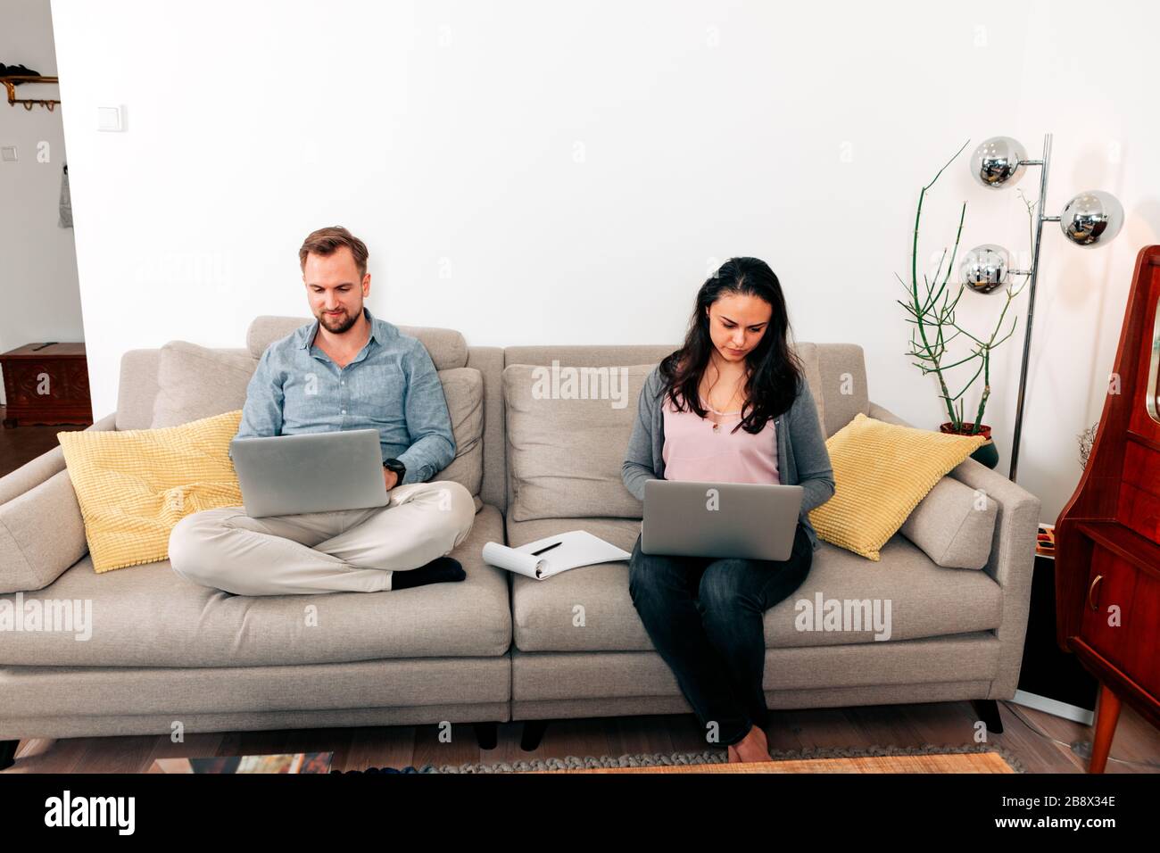 couple teleworking from home - remote work freelance or employed concept Stock Photo