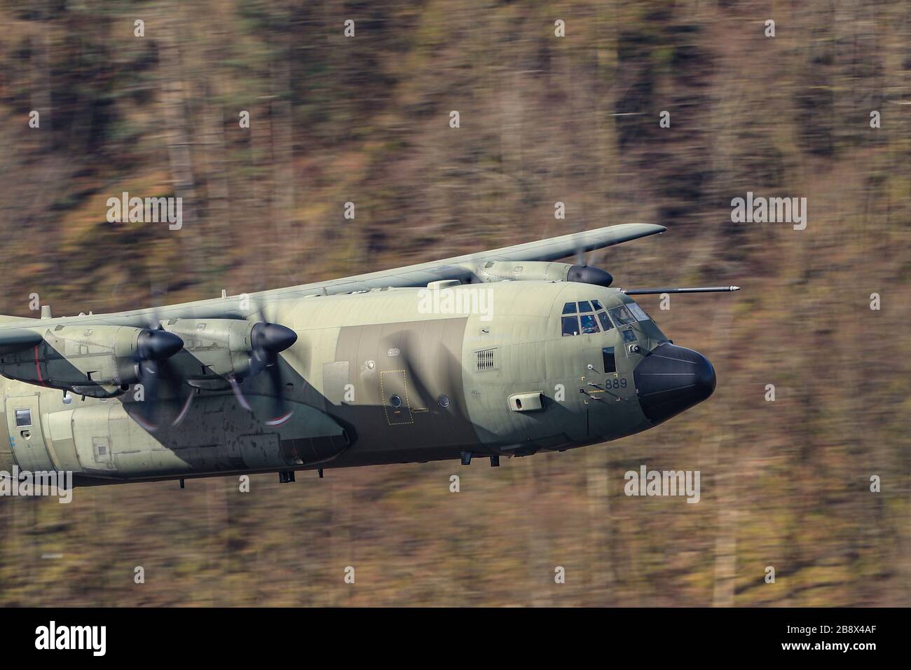 19th March 2020, Thirlmere, Allerdale, Cumbria ; The RAF in Low flying area 17 in full operational training during the corona outbreak : A RAF Lockheed C-130 Hercules in low level training over Thirlmere reservoir in the Lake District Stock Photo