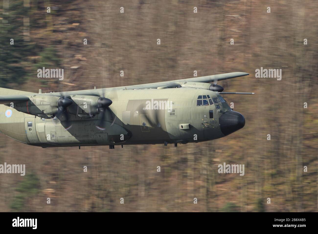 19th March 2020, Thirlmere, Allerdale, Cumbria ; The RAF in Low flying area 17 in full operational training during the corona outbreak : A RAF Lockheed C-130 Hercules in low level training over Thirlmere reservoir in the Lake District Stock Photo