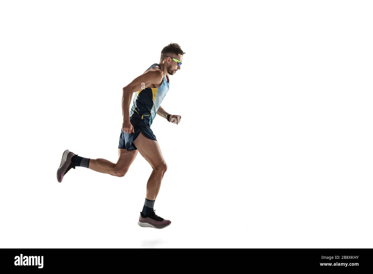 Triathlon male athlete running isolated on white studio background