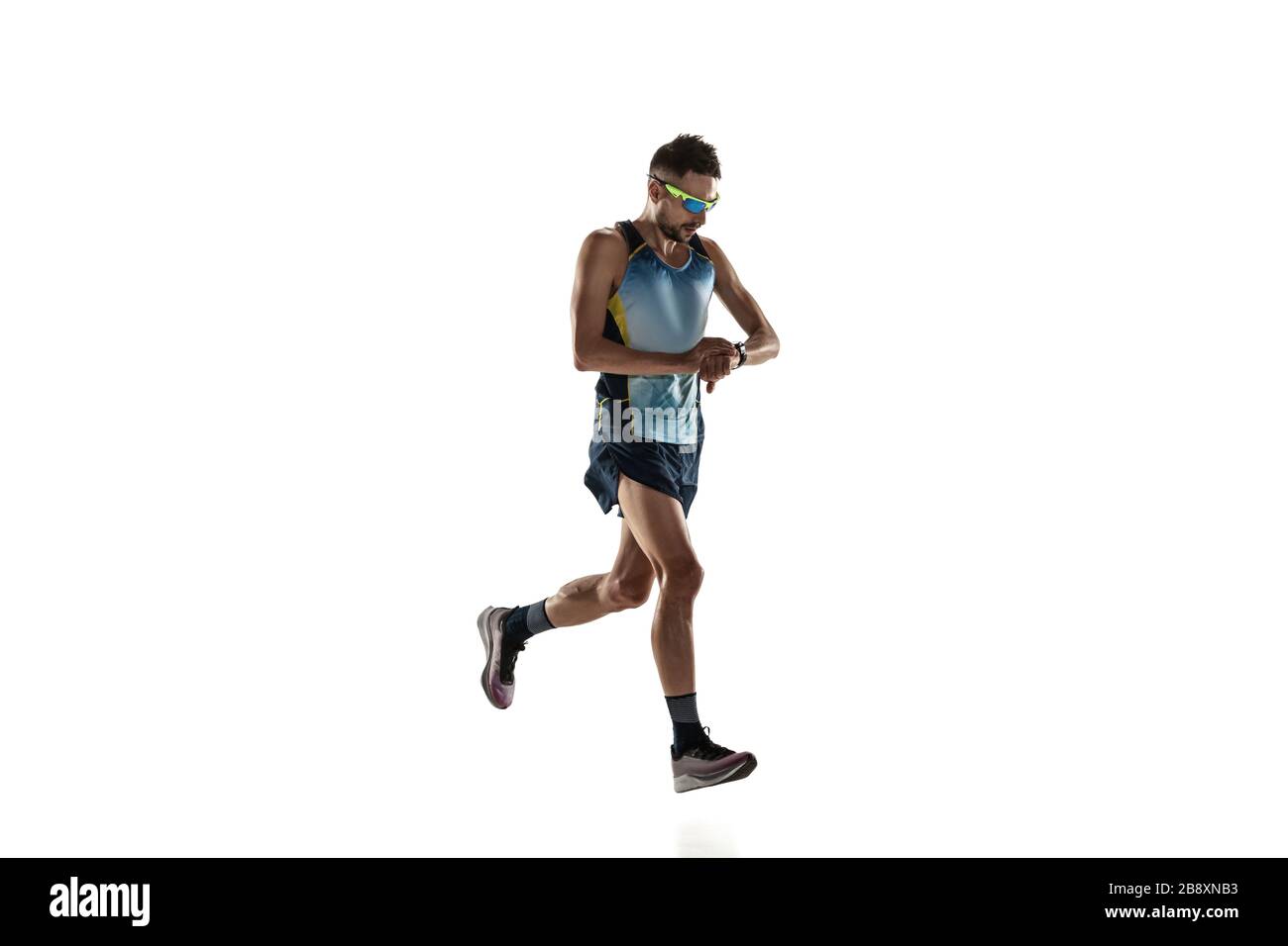 Triathlon male athlete running isolated on white studio background
