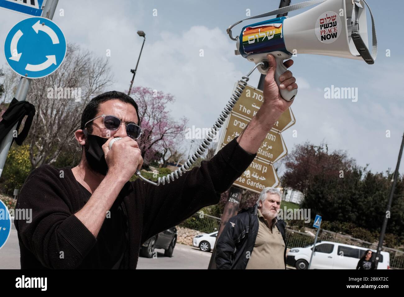 Jerusalem, Israel. 23rd Mar, 2020. The Black Flags Movement brings a convoy of over 1,000 cars to the Knesset, the Israeli Parliament, waving Israeli and black flags, protesting the Netanyahu government's alleged attempt to manipulate legislation and abuse Coronavirus emergency measures in an attempt to ‘hijack' democracy for political and personal benefits. A Supreme Court appeal is now underway aiming to restore the full powers of Parliament, blocked from functioning by Knesset Speaker, Edelstein, a Netanyahu ally. Credit: Nir Alon/Alamy Live News Stock Photo