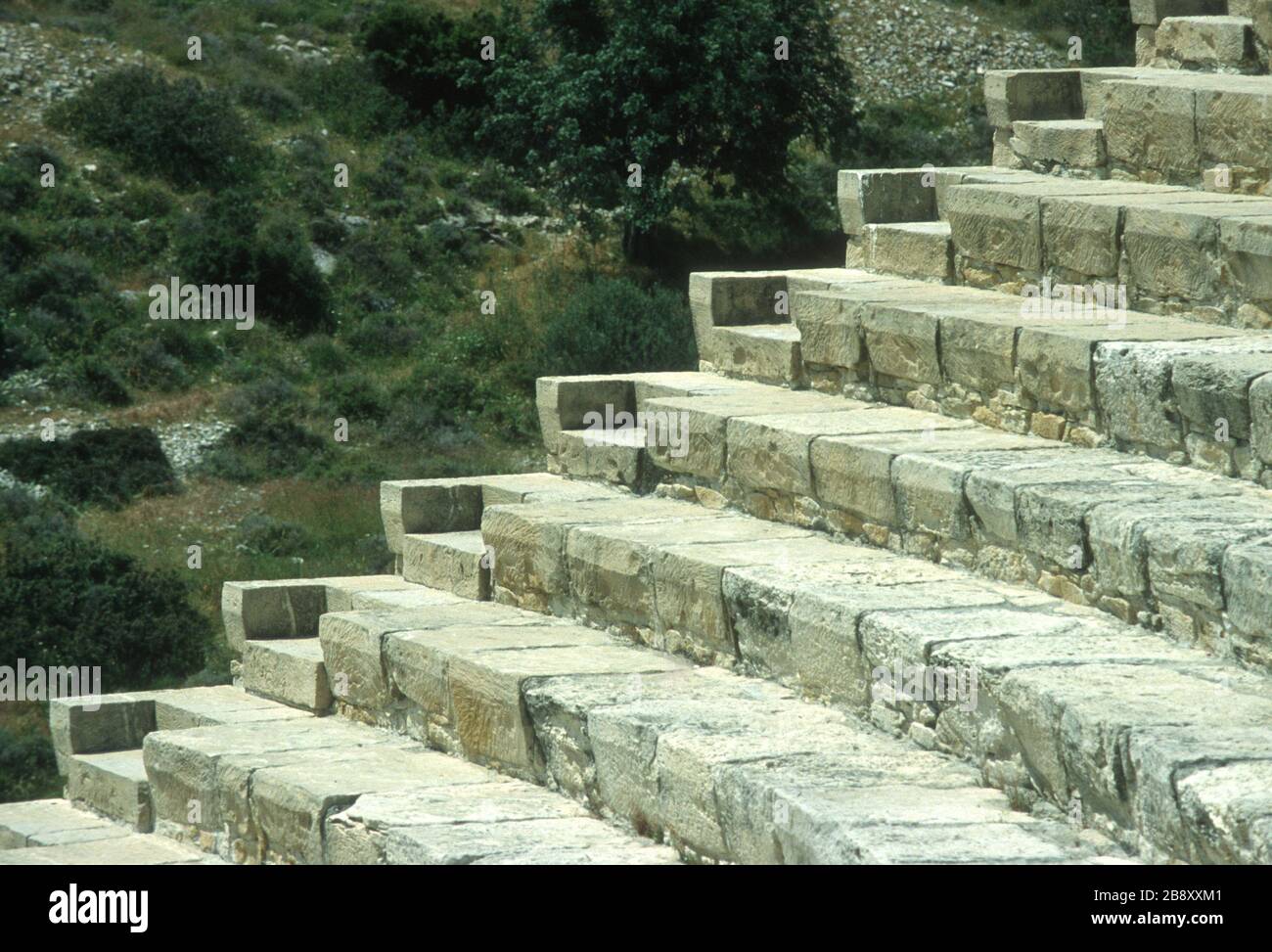 Remains of the spectacular, cliff-top Greek theatre in Kourion, Episkopi, Limassol, Cyprus. Stone seating in circular rows in the auditorium and the steps used to reach each level. Stock Photo