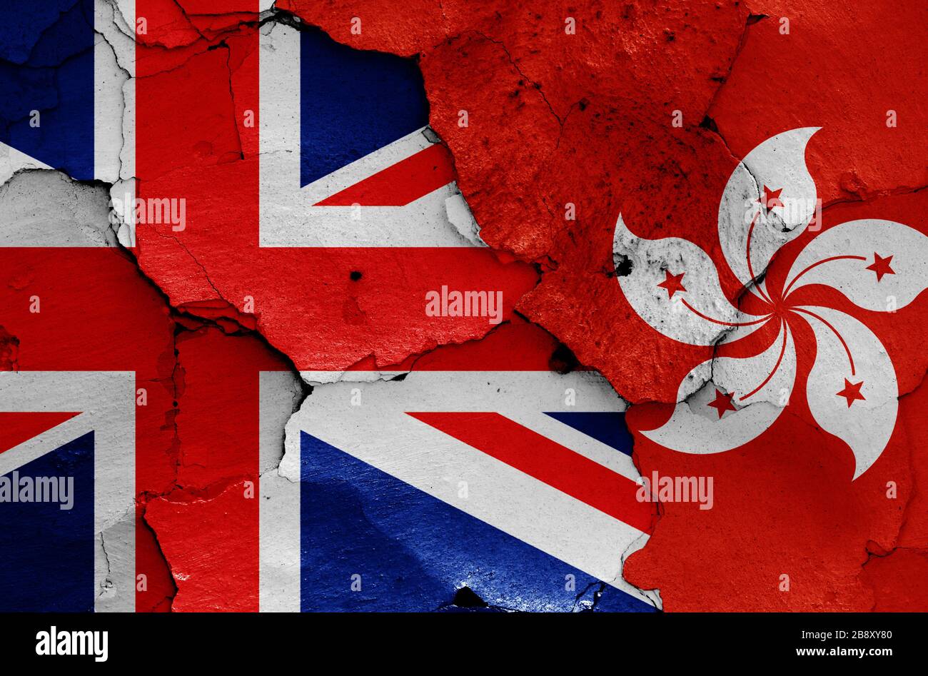 flags of UK and Hong Kong painted on cracked wall Stock Photo