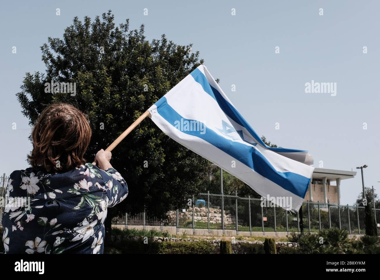 Jerusalem, Israel. 23rd Mar, 2020. The Black Flags Movement brings a convoy of over 1,000 cars to the Knesset, the Israeli Parliament, waving Israeli and black flags, protesting the Netanyahu government's alleged attempt to manipulate legislation and abuse Coronavirus emergency measures in an attempt to ‘hijack' democracy for political and personal benefits. A Supreme Court appeal is now underway aiming to restore the full powers of Parliament, blocked from functioning by Knesset Speaker, Edelstein, a Netanyahu ally. Credit: Nir Alon/Alamy Live News Stock Photo