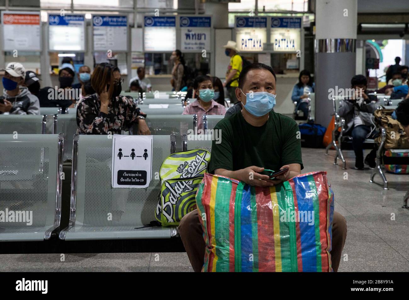 Bangkok, Bangkok, Thailand. 23rd Mar, 2020. Social distancing signs placed on seats in Bangkok's Mochit bus terminal. The travel hub was filled with thousands of travelers heading back to their home provinces after the city government ordered the mandatory closure of many nonessential businesses on March 22nd, 2020 in an effort to slow the spread of the Covid-19 virus. Large portions of the capital's workforce live paycheck to pay check, making staying in the city financially impossible due to their sudden lack of employment. Credit: ZUMA Press, Inc./Alamy Live News Stock Photo