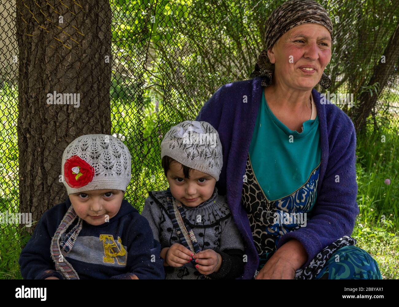 Bartang, Tajikistan - June 17, 2020: Family with mother and two children in the Bartang Vally at the Pamir Highway in Tajikistan. Stock Photo