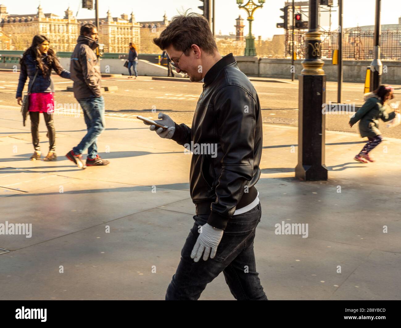 A man wearing white latex gloves talks on his mobile phone on Waterloo Bridge Stock Photo Alamy