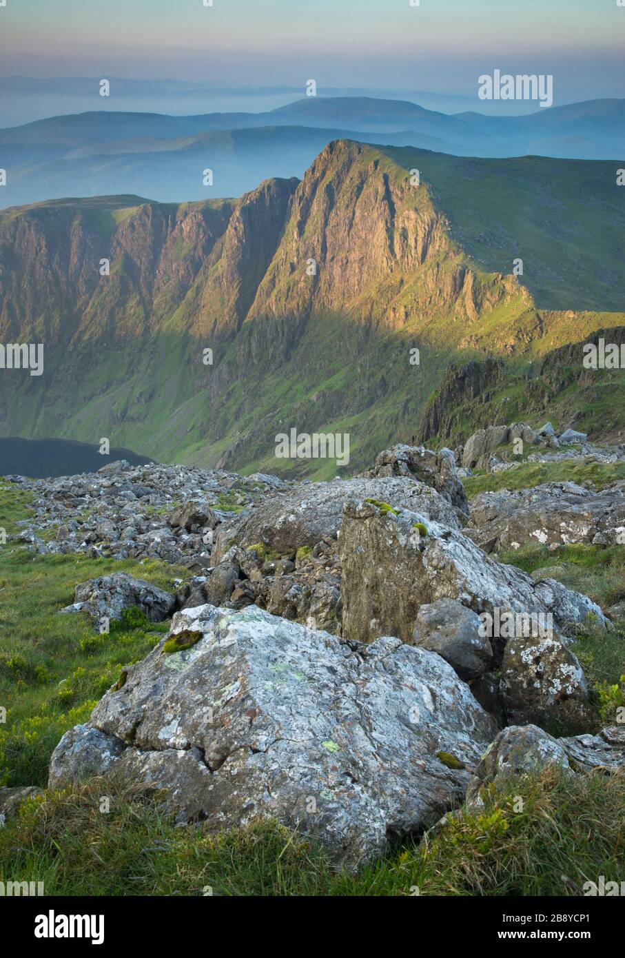 Wide views in lovely warm light near the summit of Cadair Idris, a high mountain near Dolgellau in North Wales, UK. Stock Photo