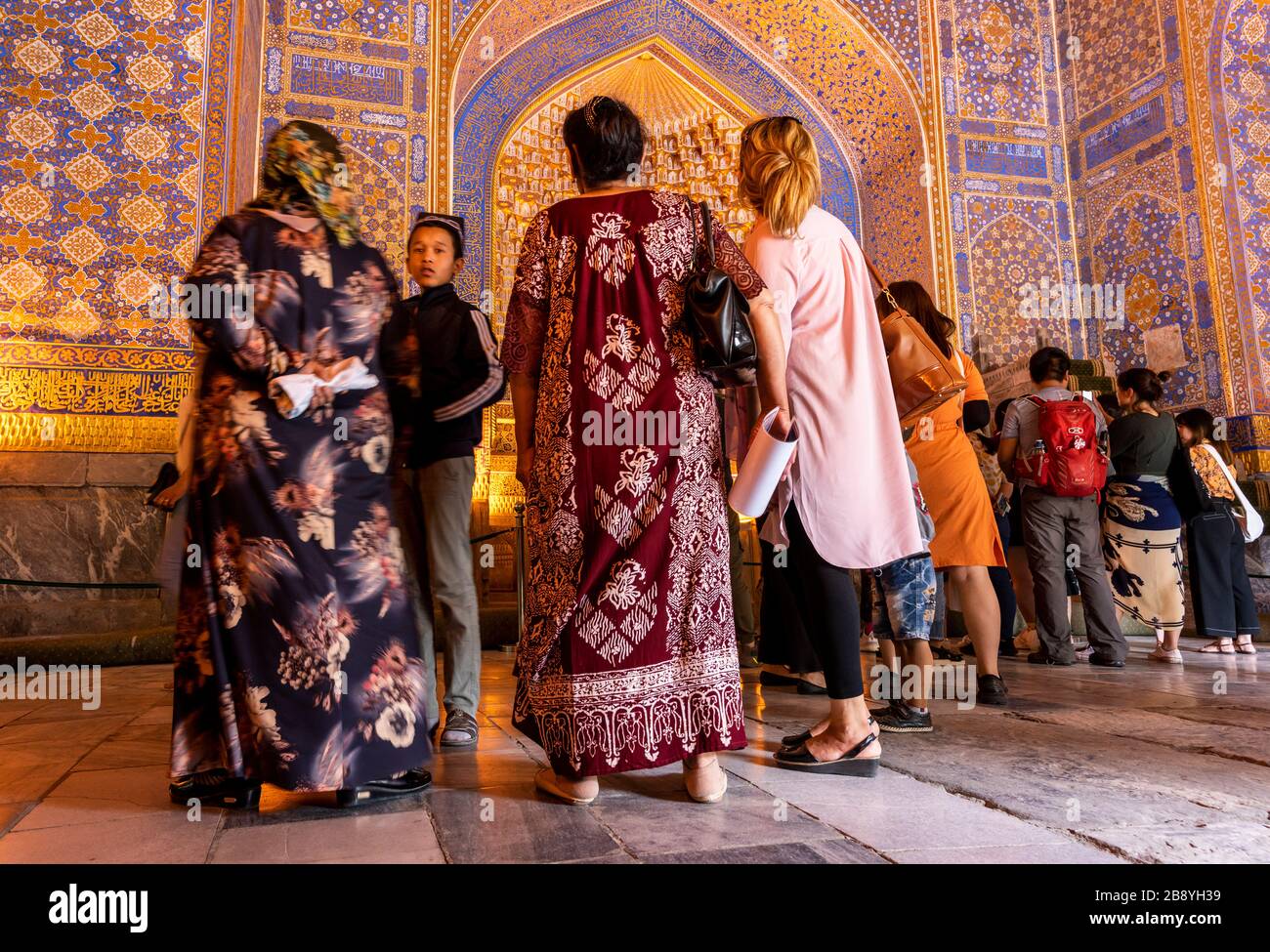 Samarqand, Uzbekistan - June 9, 2019: Touristsin the Tillya-Kori Madrasah in the centre of Samarqand in Uzbekistan. Stock Photo