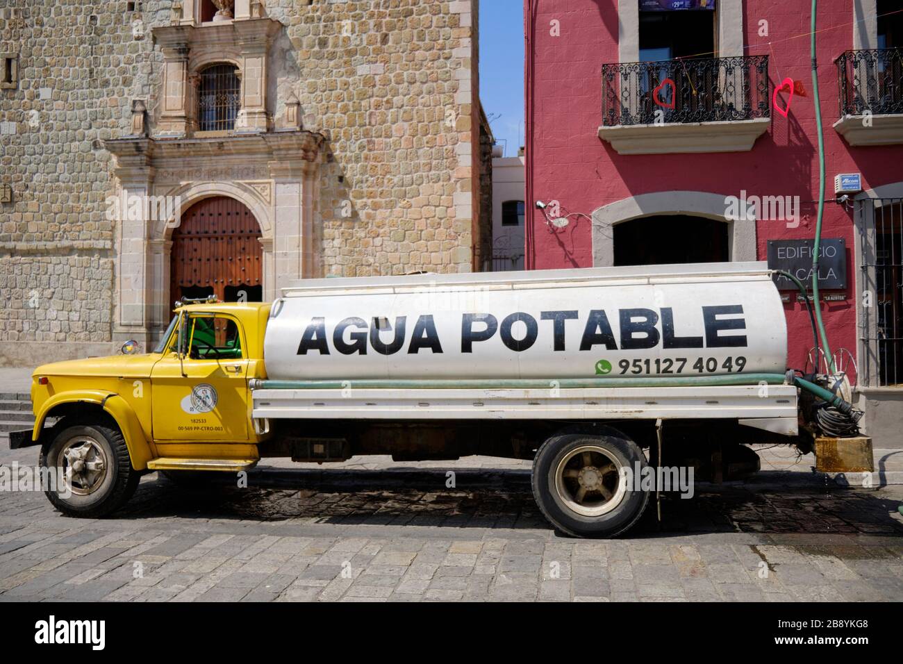 Cistern truck delivering drinking water to an establishment in old town Oaxaca, Mexico Stock Photo