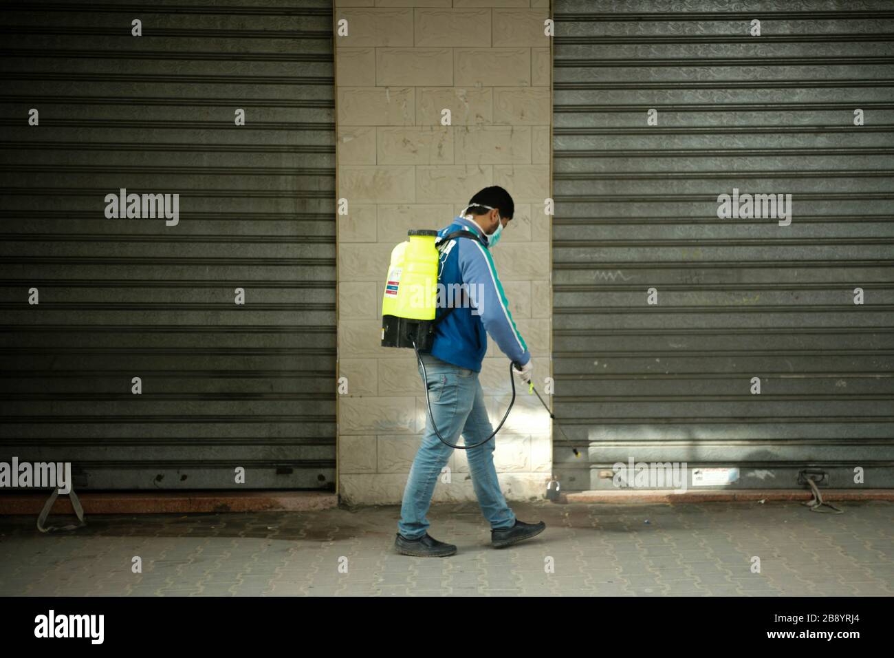 Gaza, Palestine. 23rd Mar, 2020. A member of a volunteer group carries out disinfection works as a precaution against the coronavirus (COVID-19) pandemic at a shopping area in Beit Lahia, north of Gaza, Gaza. (Photo by Ramez Habboub/Pacific Press) Credit: Pacific Press Agency/Alamy Live News Stock Photo