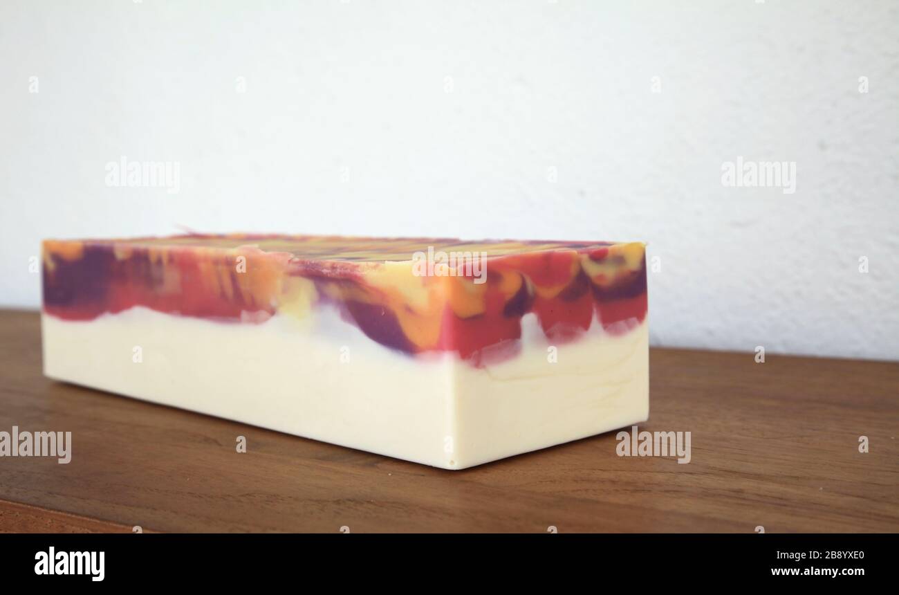 Block of handmade cold process soap on wooden surface Stock Photo