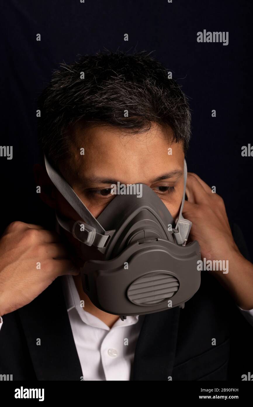 Young handsome with industrial mask to prevent the spread of contagious ...