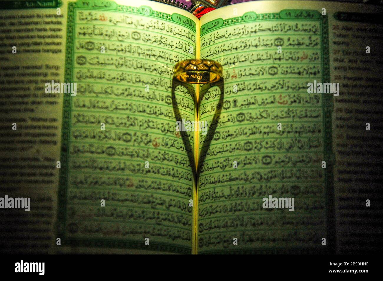 Shadow of love on Quran Stock Photo