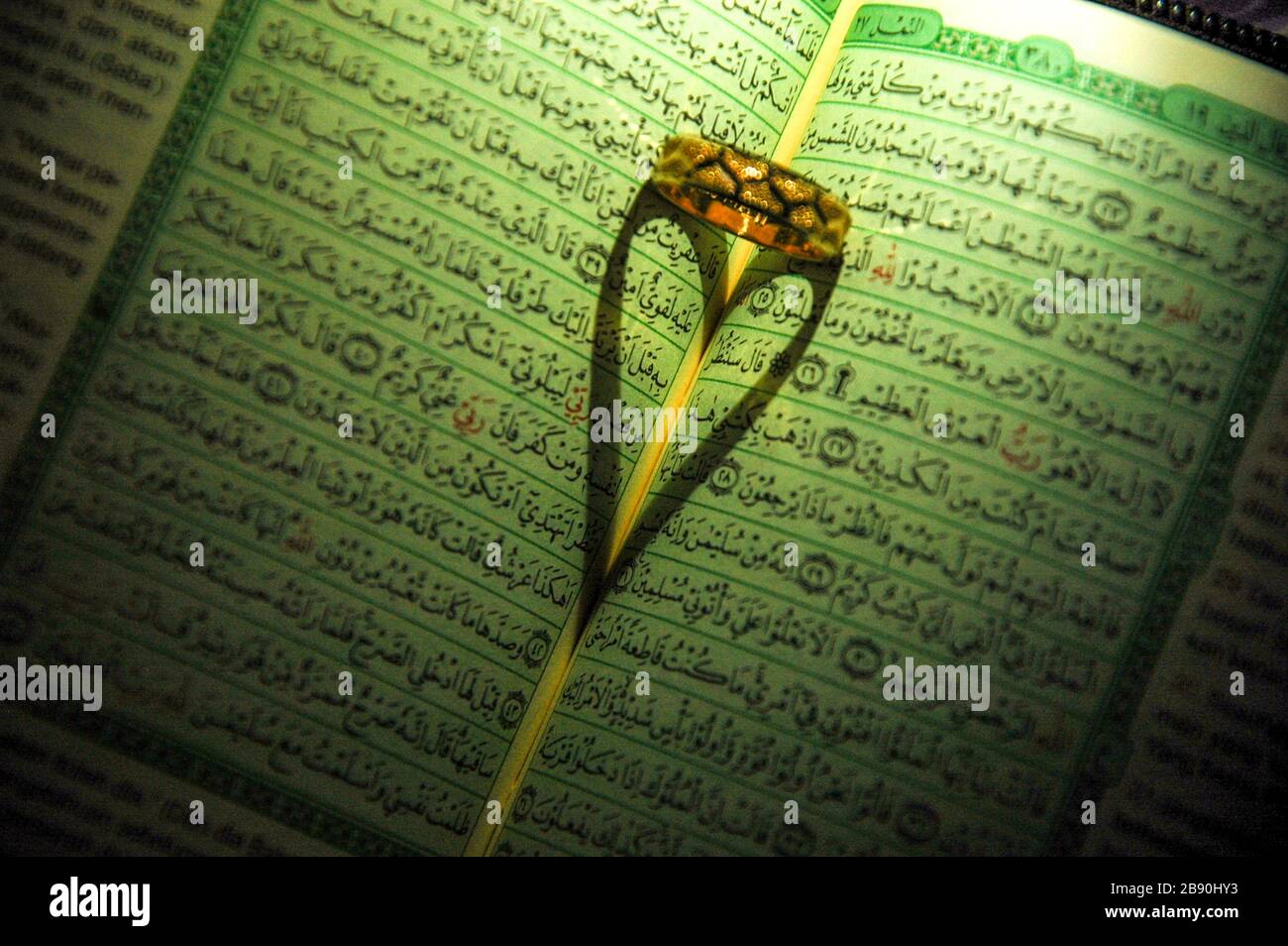 Ring Shadow On  Al Quran Stock Photo